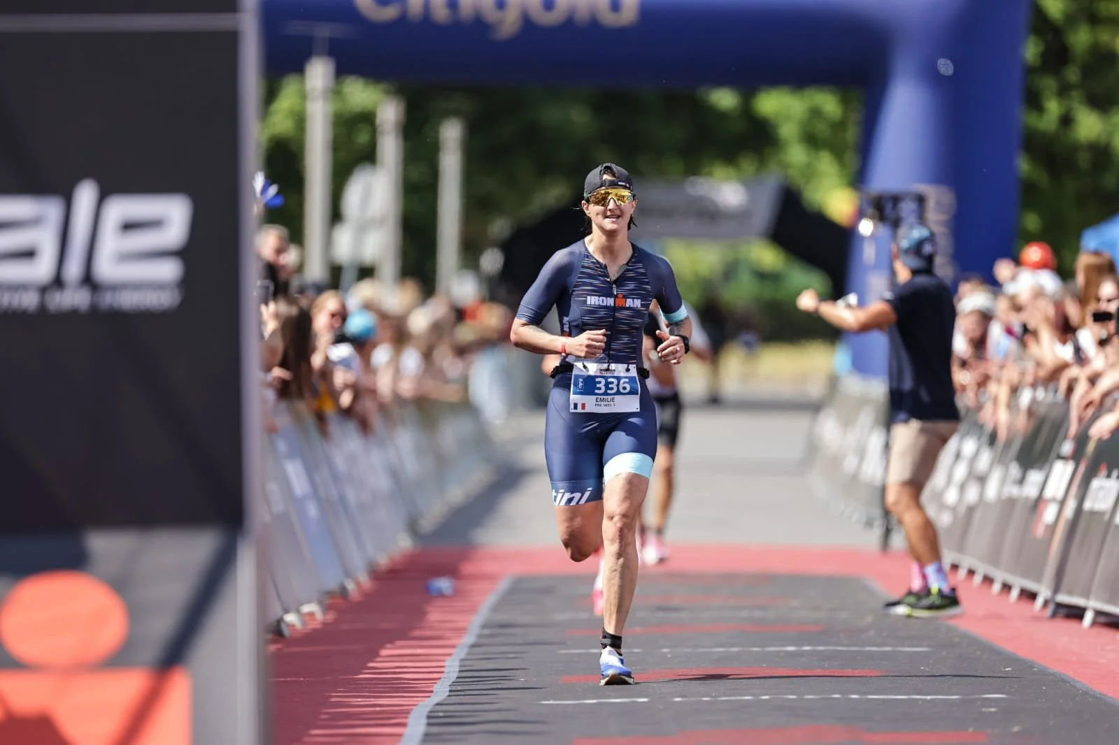 Emilie running down a marathon finish chute